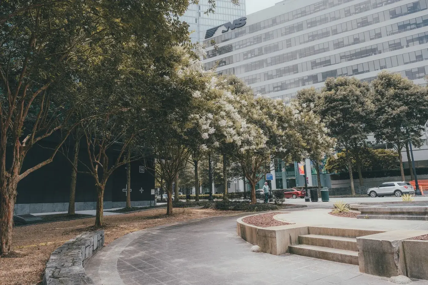 A tree-lined public space among buildings in downtown Atlanta